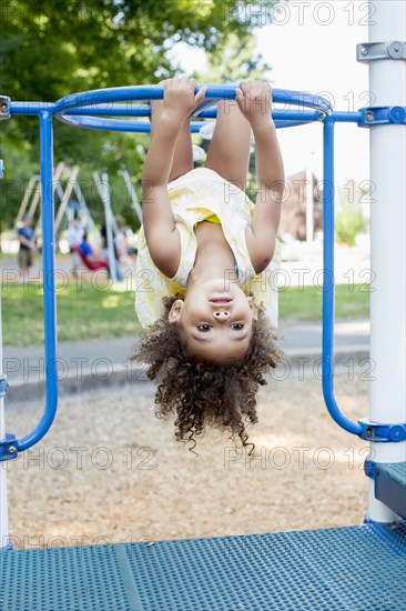 Mixed race girl playing on playground