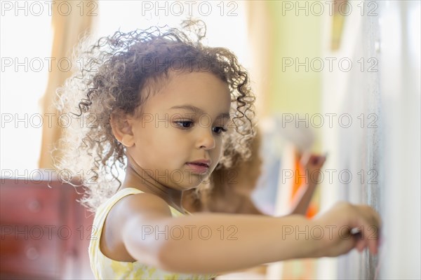 Mixed race girl drawing