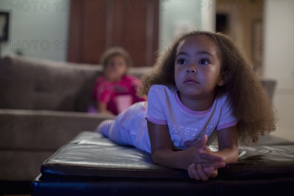 Mixed race girls watching television