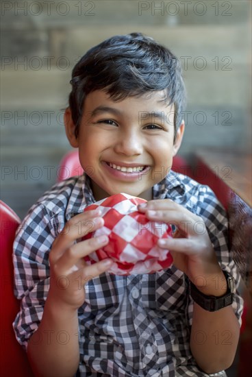 Smiling boy holding burger