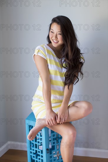 Japanese woman smiling on stool