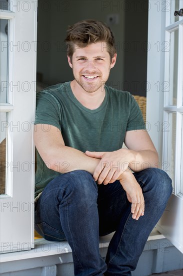 Man sitting in doorway