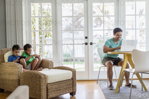 Hispanic family relaxing in living room