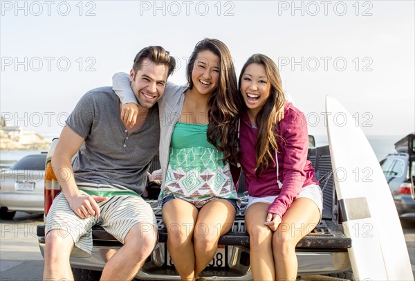 Friends relaxing together on truck bed