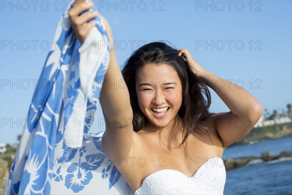 Japanese woman smiling on beach