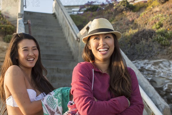 Women standing by steps on beach