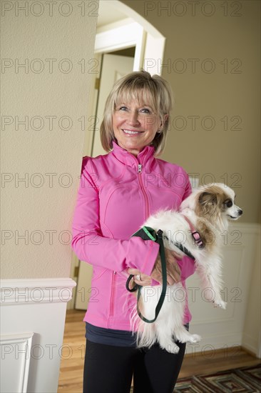 Caucasian woman holding dog