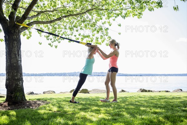 Caucasian woman working with trainer outdoors