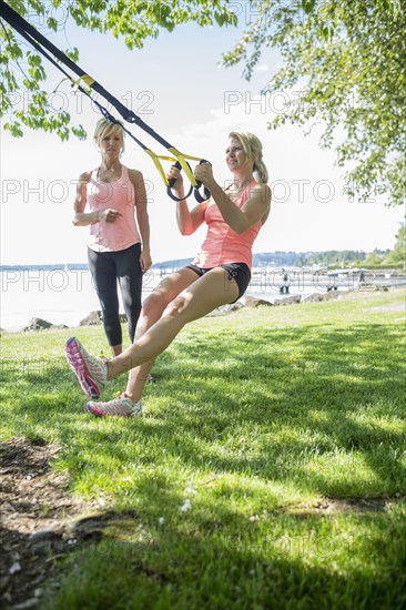 Caucasian woman working with trainer outdoors