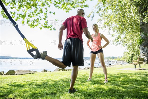 Caucasian man working with trainer outdoors