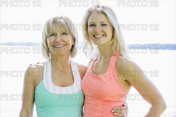 Caucasian mother and daughter smiling outdoors