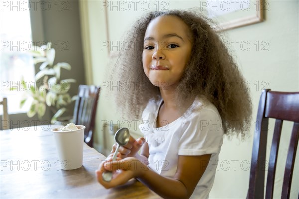 Mixed race girl enjoying hot chocolate
