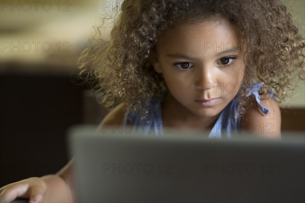 Mixed race girls using laptop