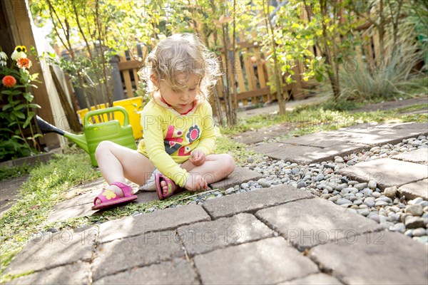 Caucasian girl playing in backyard