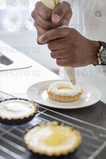 Black chef making key lime tart in restaurant