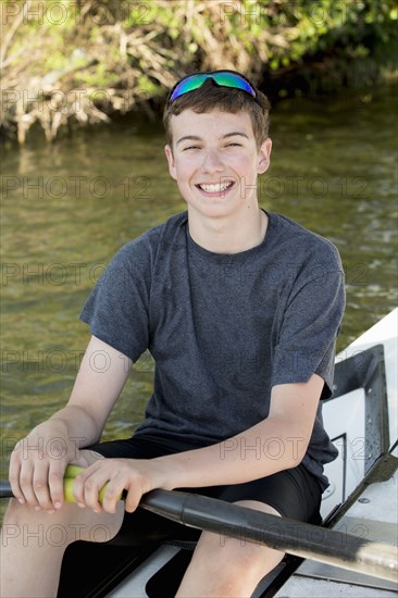 Caucasian boy smiling in kayak