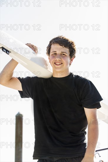 Mixed race boy carrying scull outdoors