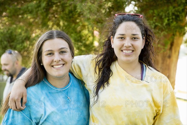 Caucasian teenage girls hugging outdoors