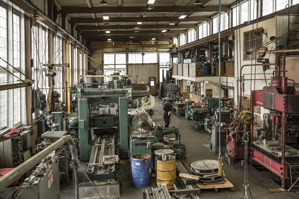 Caucasian man walking through metal shop