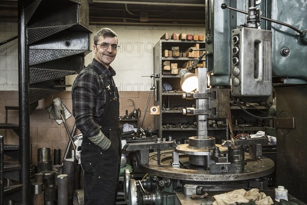 Portrait of Caucasian man smiling in metal shop