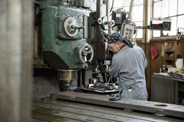 Man using machinery in metal shop