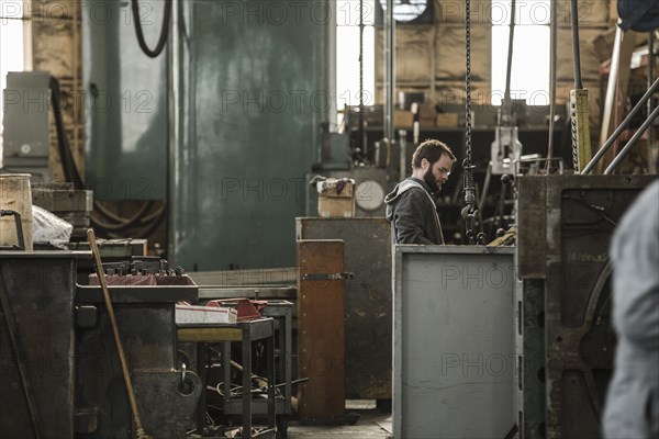 Caucasian man using machinery in workshop