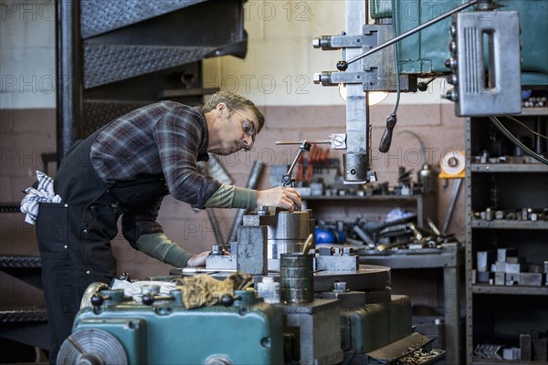 Caucasian man working in metal shop