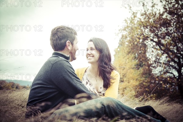 Caucasian couple sitting outdoors