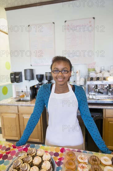 Mixed race girl baking in kitchen