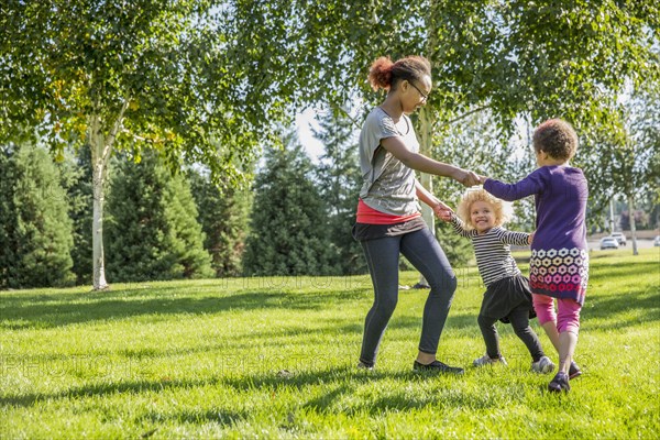 Mixed race sisters playing outdoors