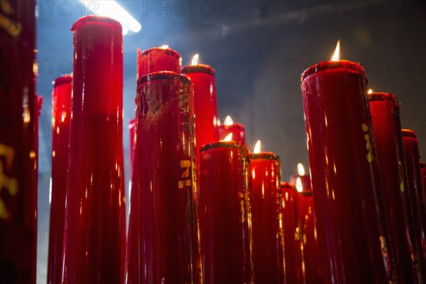 Burning candles in Buddhist temple