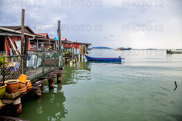 Boat docked along boathouses