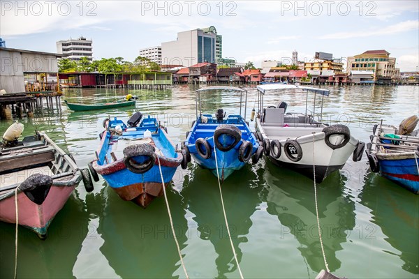 Fishing boats docked in urban harbor