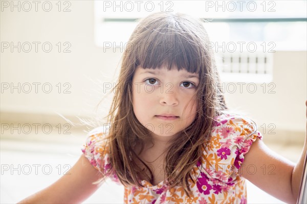 Caucasian girl sitting indoors