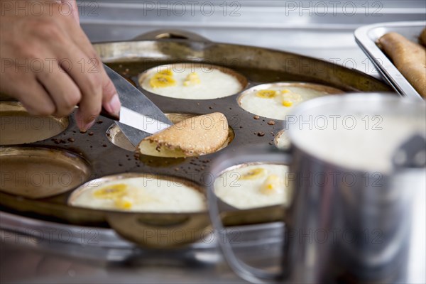 Chef flipping banana pancakes in restaurant