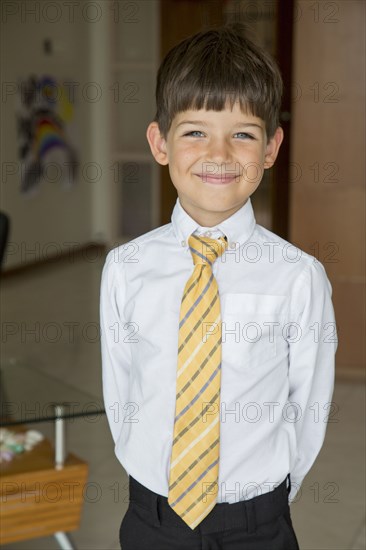 Caucasian boy smiling in formal wear