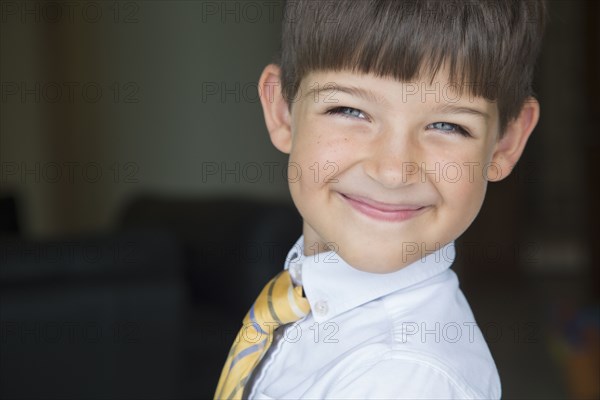 Caucasian boy smiling in formal wear