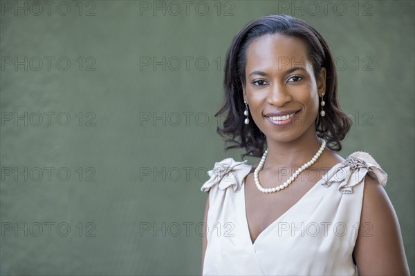 Black woman wearing white gown