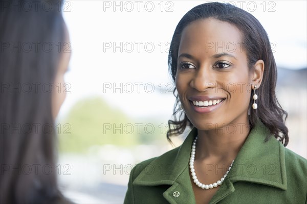 Businesswomen talking outdoors