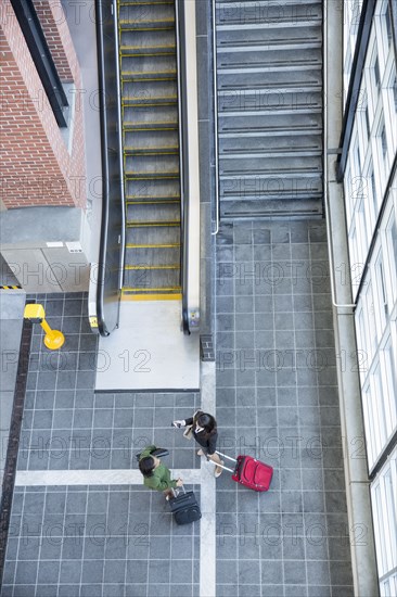 Businesswomen talking near stairs and escalator