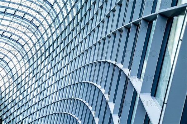 Close up of curved metal and glass building