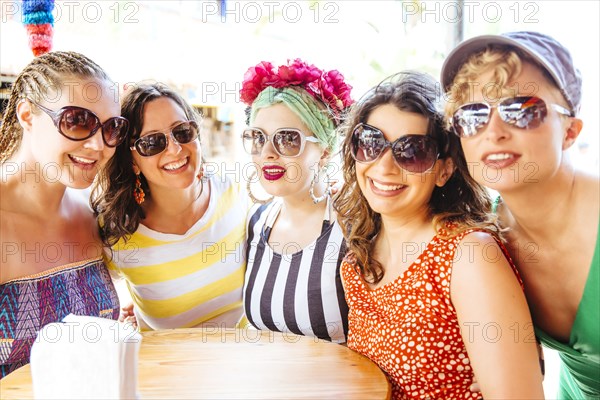 Women wearing sunglasses together at cafe