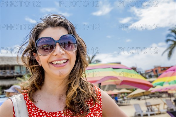 Mixed race woman smiling on tropical beach