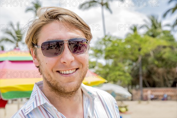 Caucasian man smiling on tropical beach