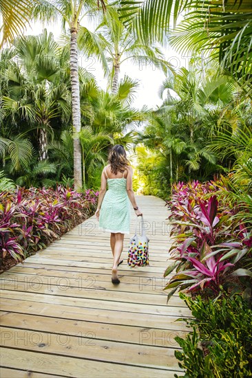 Mixed race woman on tropical walkway