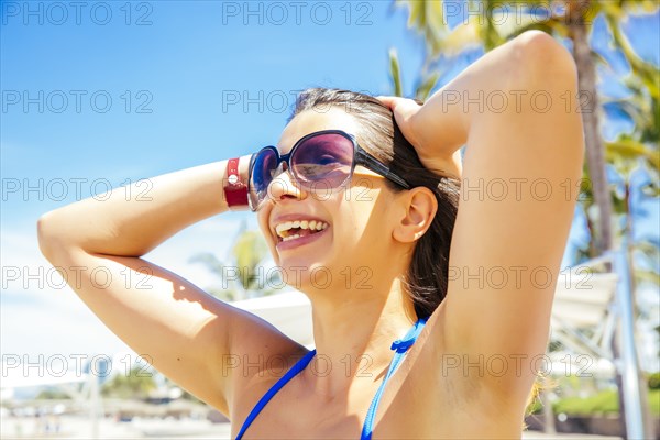 Mixed race woman smiling on beach