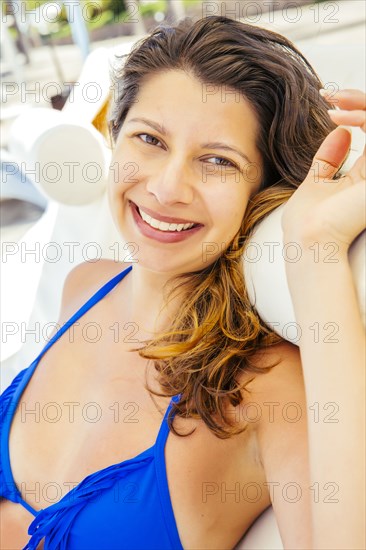 Mixed race woman relaxing on beach
