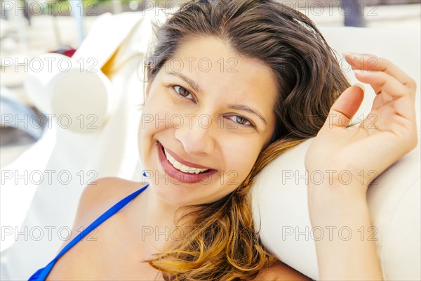 Mixed race woman relaxing on beach
