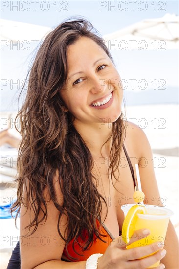 Chinese woman relaxing on beach