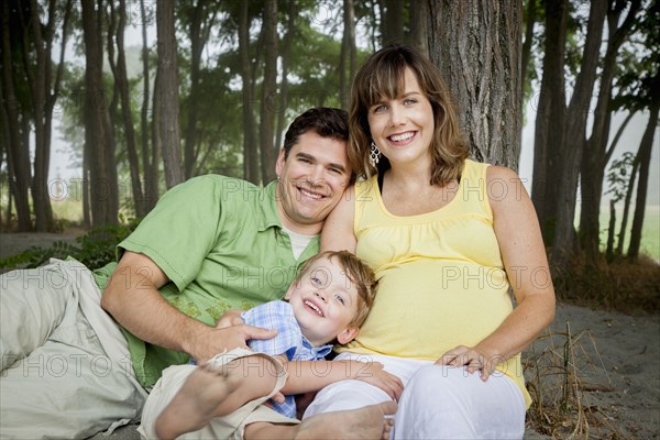 Family smiling together in forest